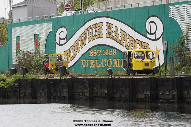 A pair of cars passing northbound past Norwich Harbor.