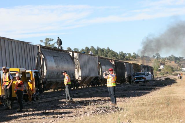 Hobos riding the tops of freight cars. Others were riding under the ends of hoppers. There may have been a dozen or so.